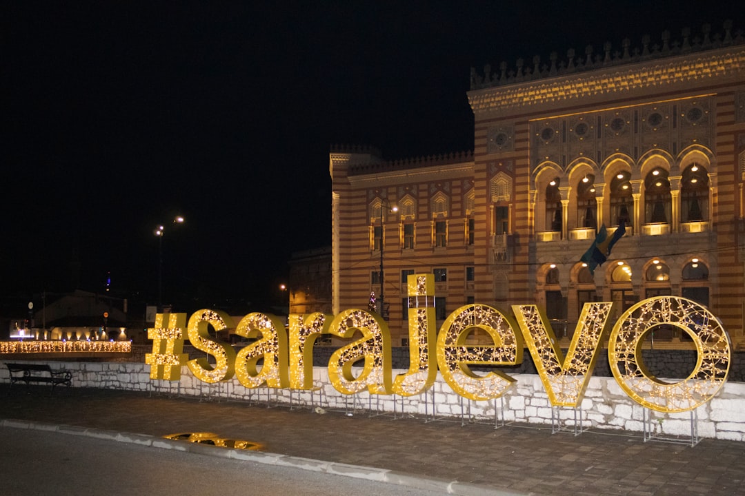 a large sign that says love is lit up in front of a building