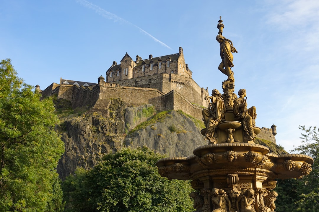 A fountain with a castle in the background