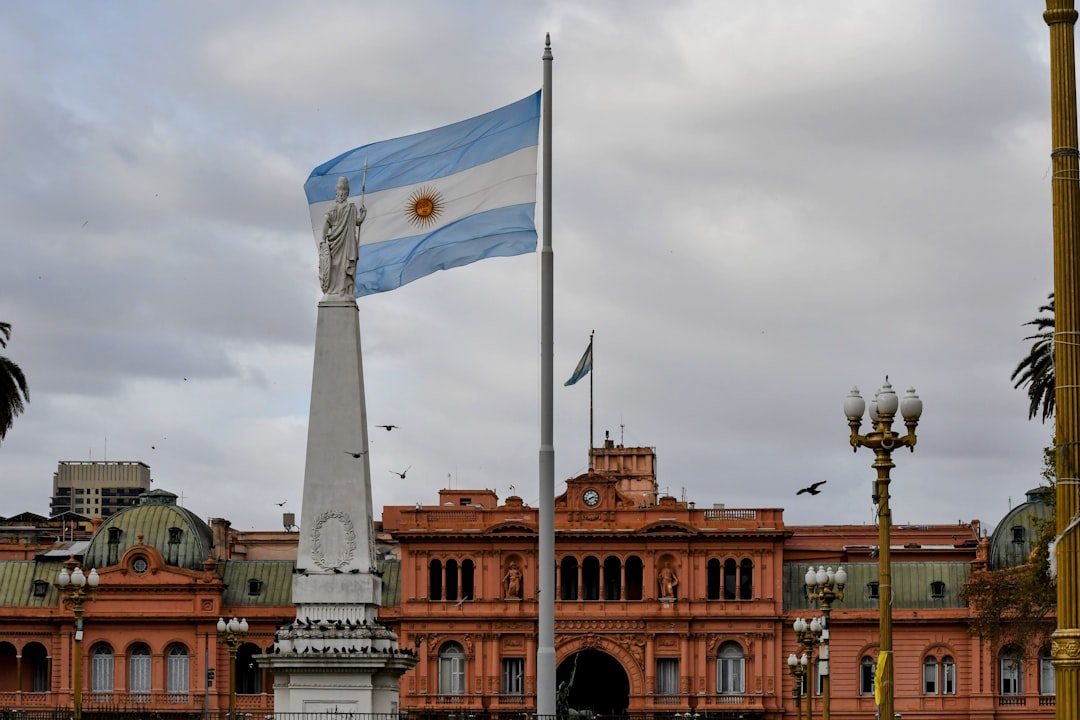 Argentinian flag waving near a prominent building.