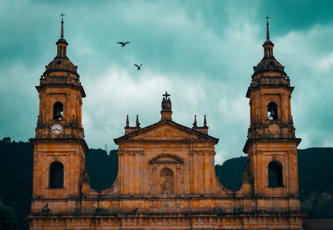 Grand cathedral with twin towers under cloudy sky