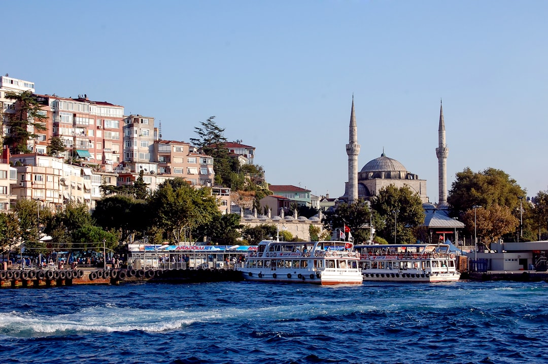 a boat traveling down a river next to a city