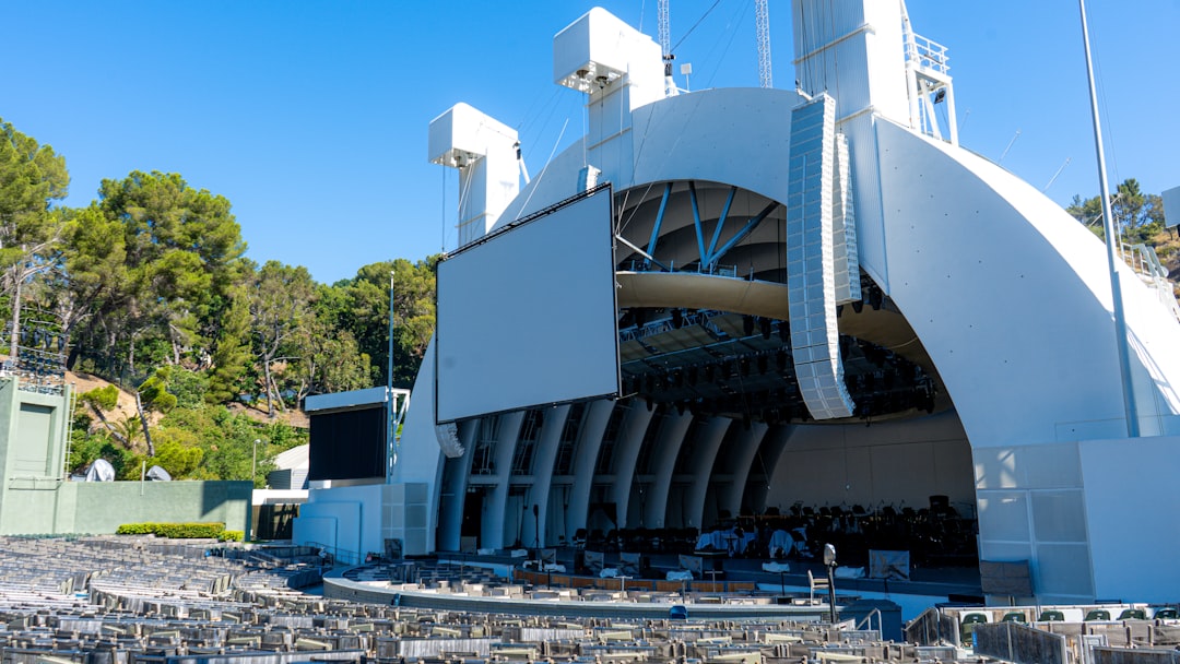 A large white building with a lot of chairs in front of it