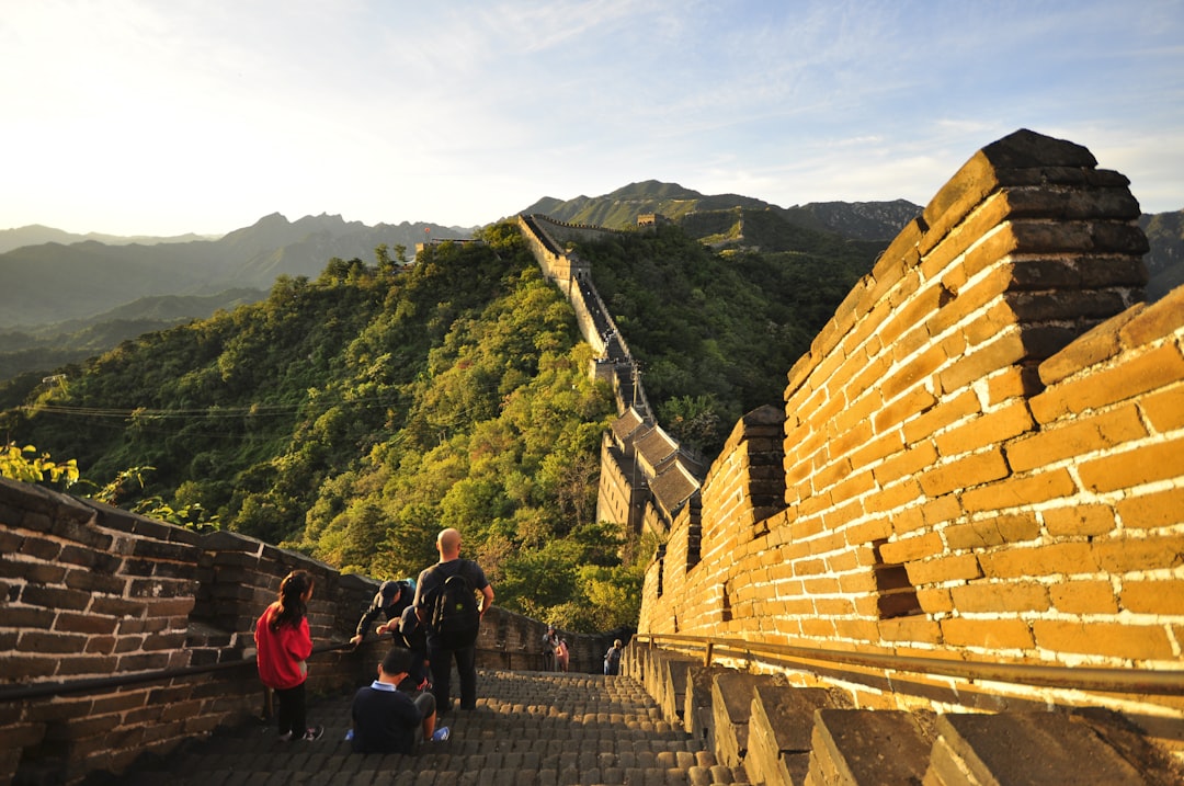 a group of people walking up the great wall of china