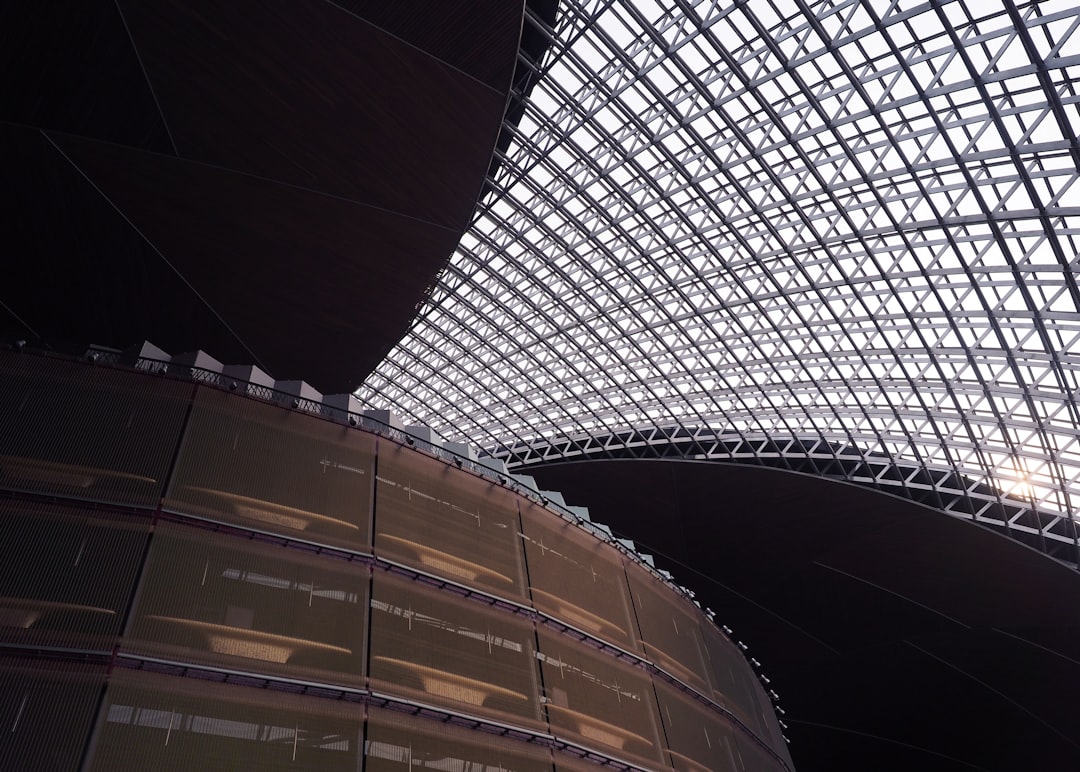 The ceiling of a large building with many windows