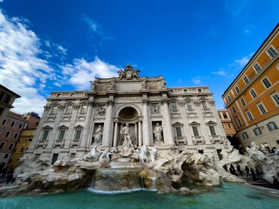 a large building with a fountain in front of it