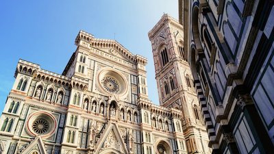 Florence's cathedral stands tall against the blue sky.