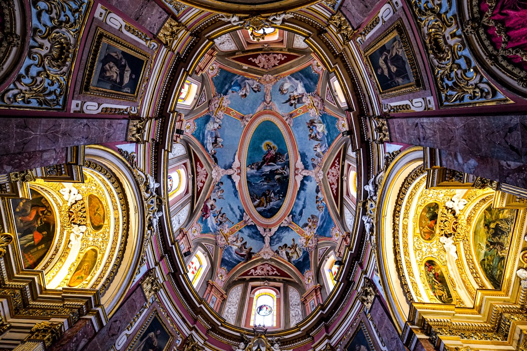 the ceiling of a church with paintings on it