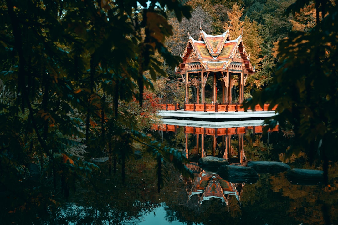 A gazebo in the middle of a lake surrounded by trees