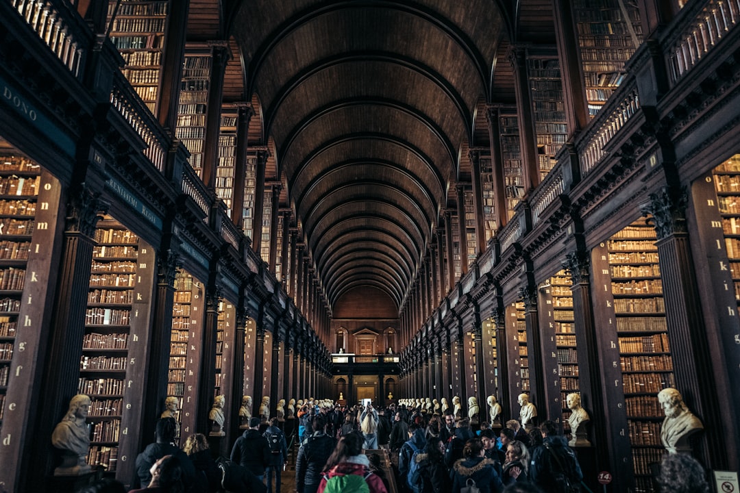 Grand library interior with towering bookshelves and people