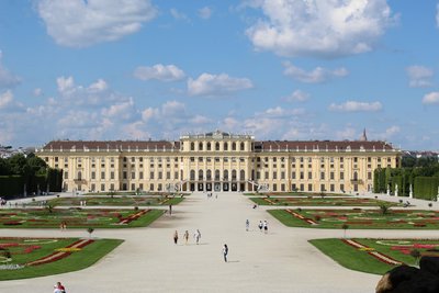 A large building with a lot of people in front of it