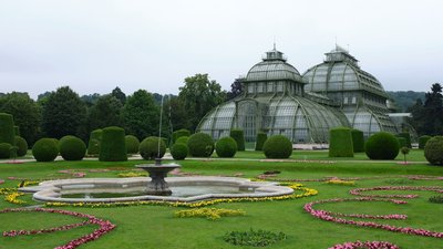 a garden with a fountain surrounded by flowers