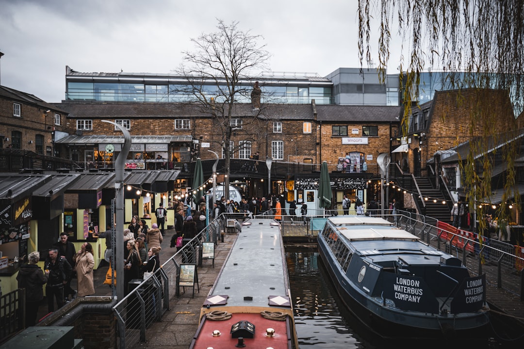 a group of people standing on a dock next to a boat