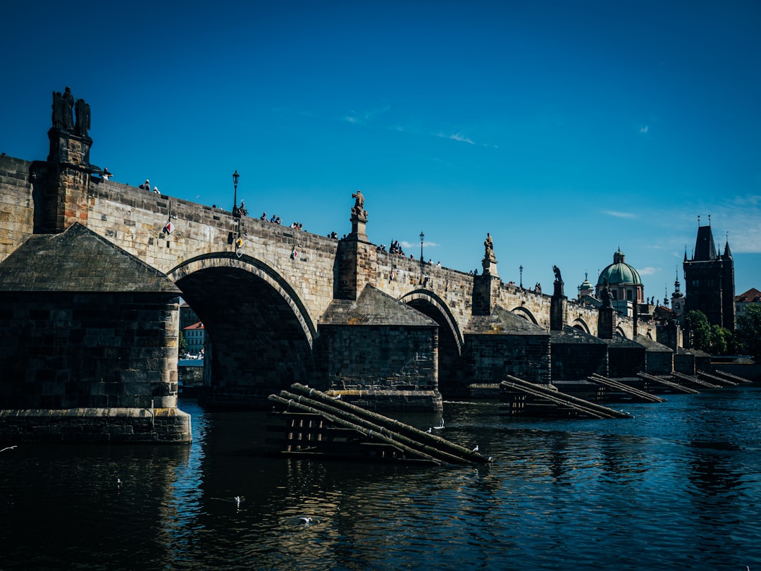 Stone bridge with arches over blue water
