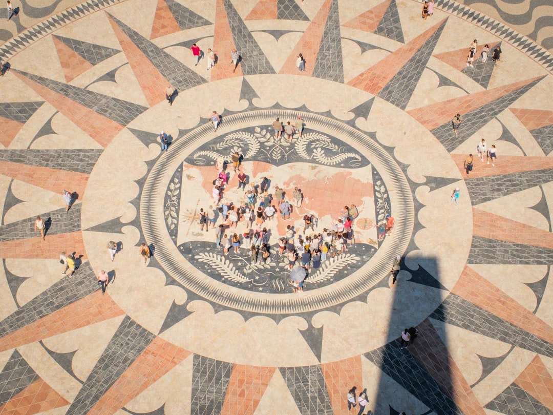 People gathered on a compass rose mosaic with map