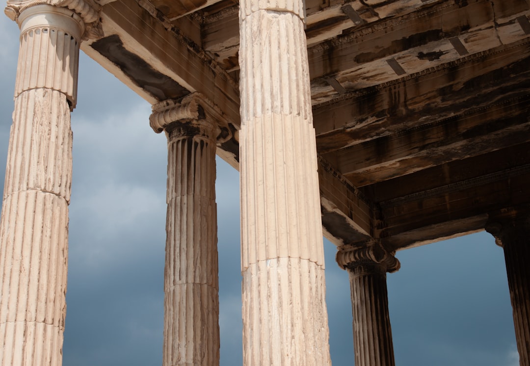 A group of pillars sitting under a cloudy sky