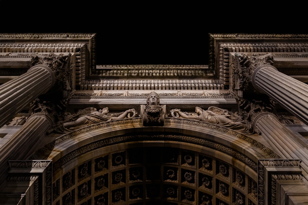 a very tall building with columns and a clock