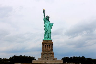 the statue of liberty is surrounded by trees