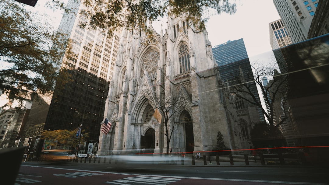 A large cathedral towering over a city filled with tall buildings