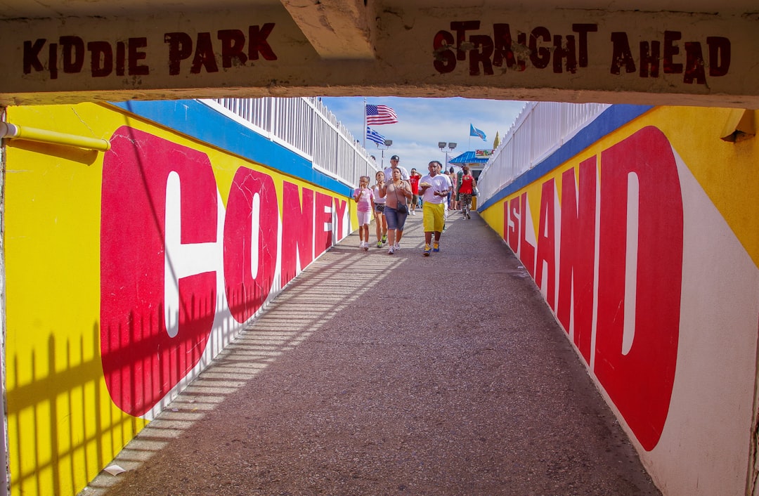 a group of people walking under a colorful sign