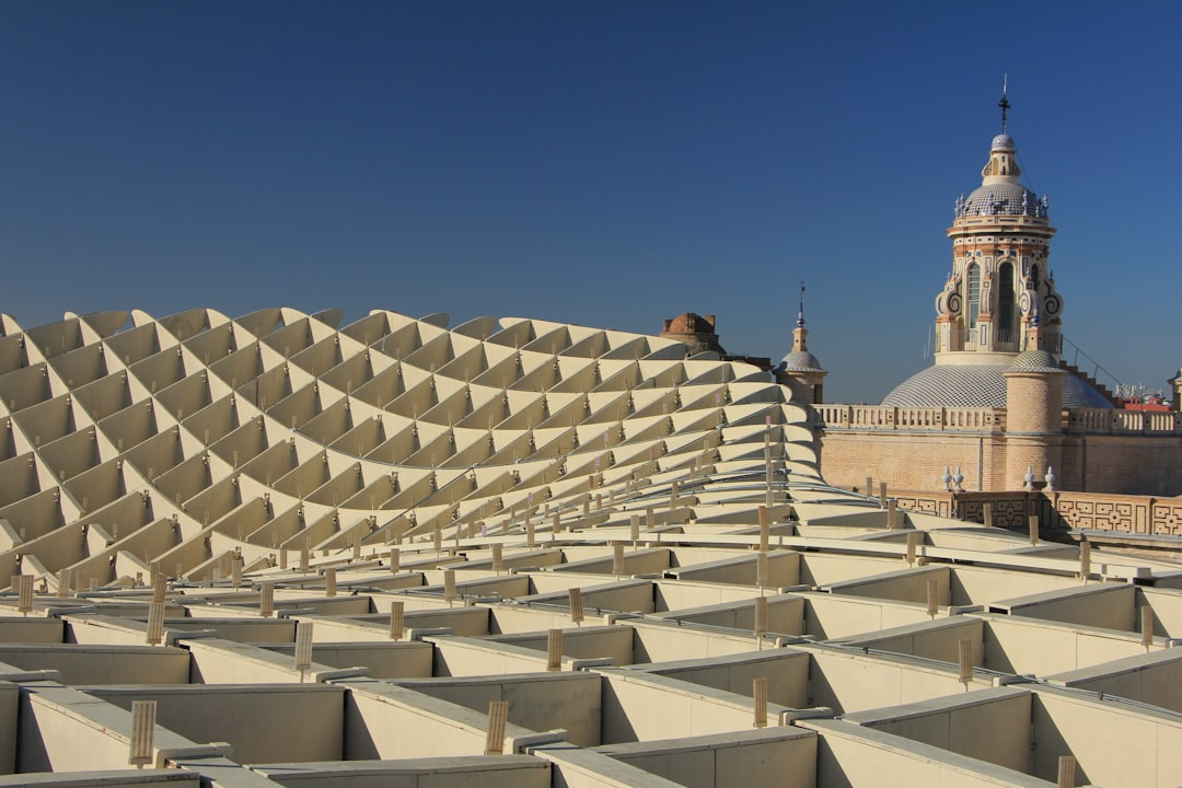 A very large building with a clock tower in the background