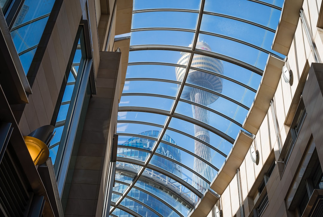 looking up at a building with glass windows