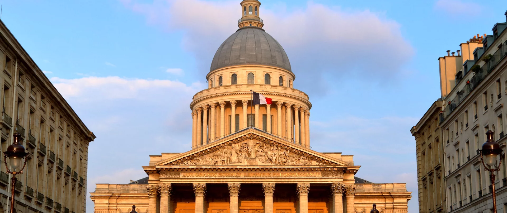 The Pantheon glowing warmly at sunset, its dome bathed in golden light.