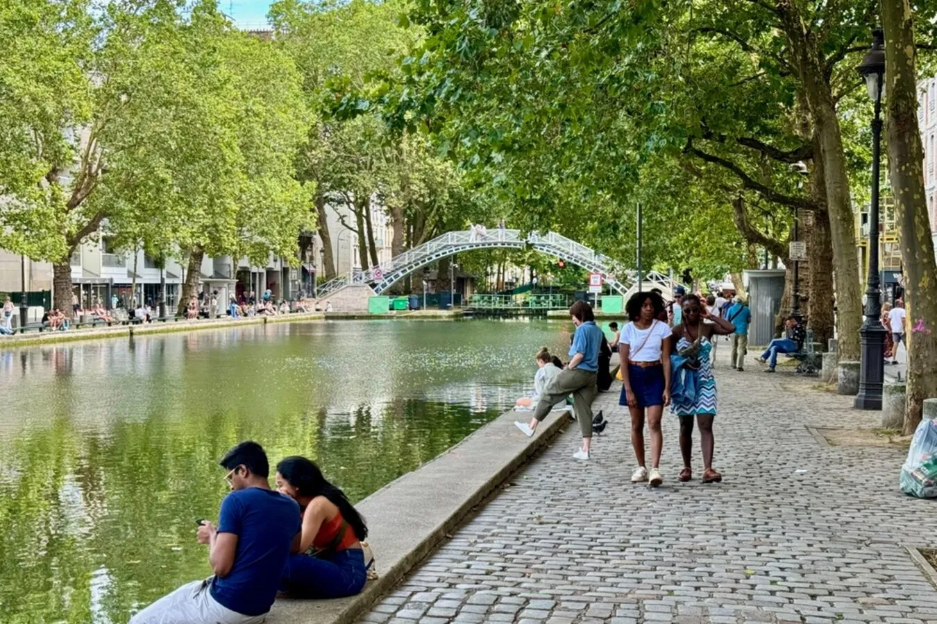 Quaint Canal Saint-Martin with charming streets, cafés, and reflections on water.