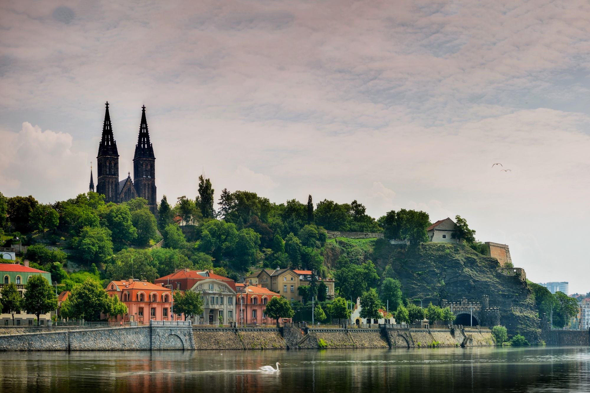 Vyšehrad Fortress overlooking Prague with ancient walls and peaceful green spaces.