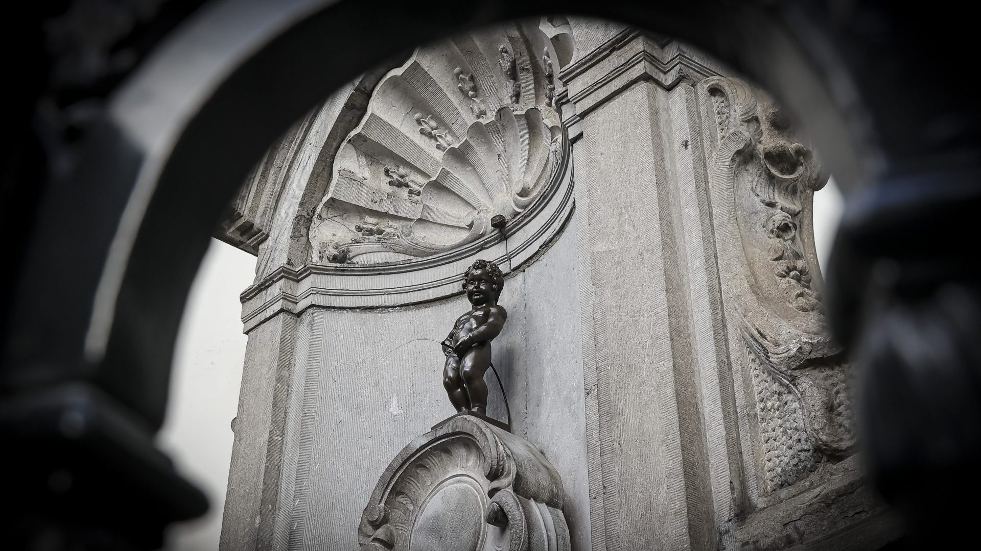 Manneken Pis, a small bronze statue in Brussels known for its playful fountain figure.
