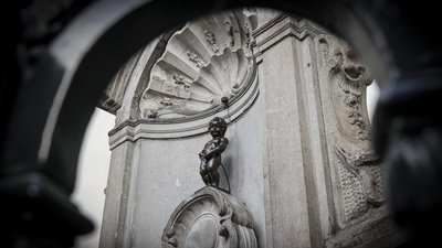 Manneken Pis, a small bronze statue in Brussels known for its playful fountain figure.